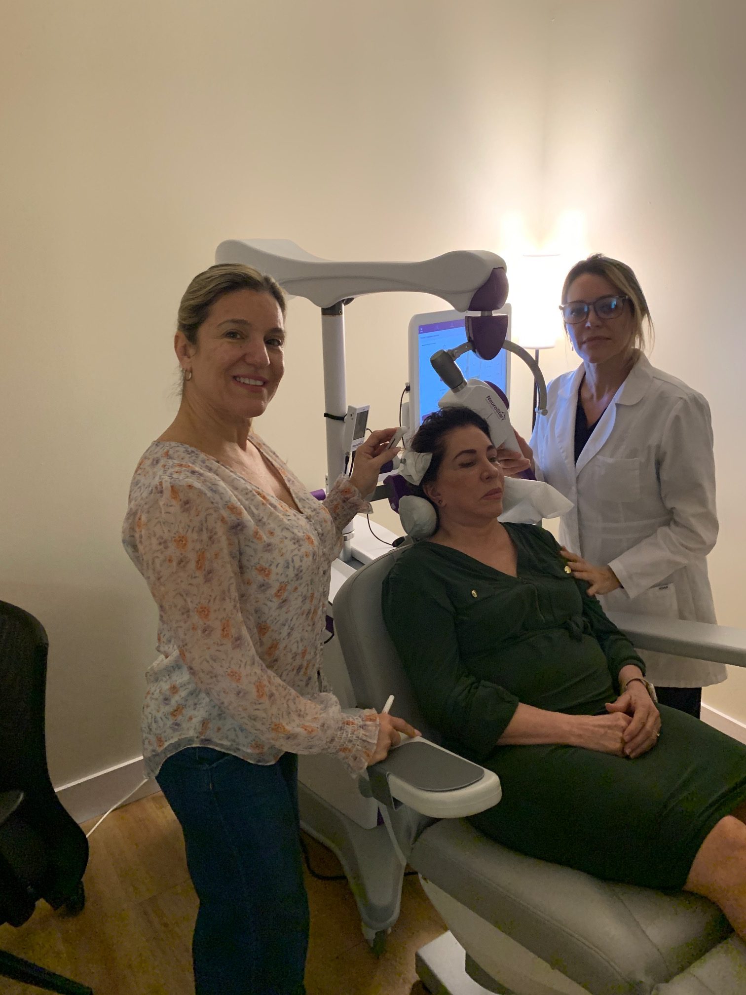 Patient undergoing NeuroStar TMS therapy with clinician support — serving Miami Florida from Boca Raton clinic